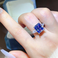 Blue Moissanite Ring 5 Carat Sapphire on a hand, showcasing its brilliant sapphire-blue gem and sterling silver setting.